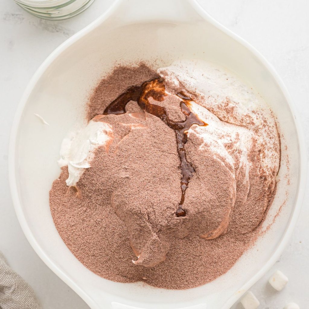 Bowl with hot chocolate mix and cream. 