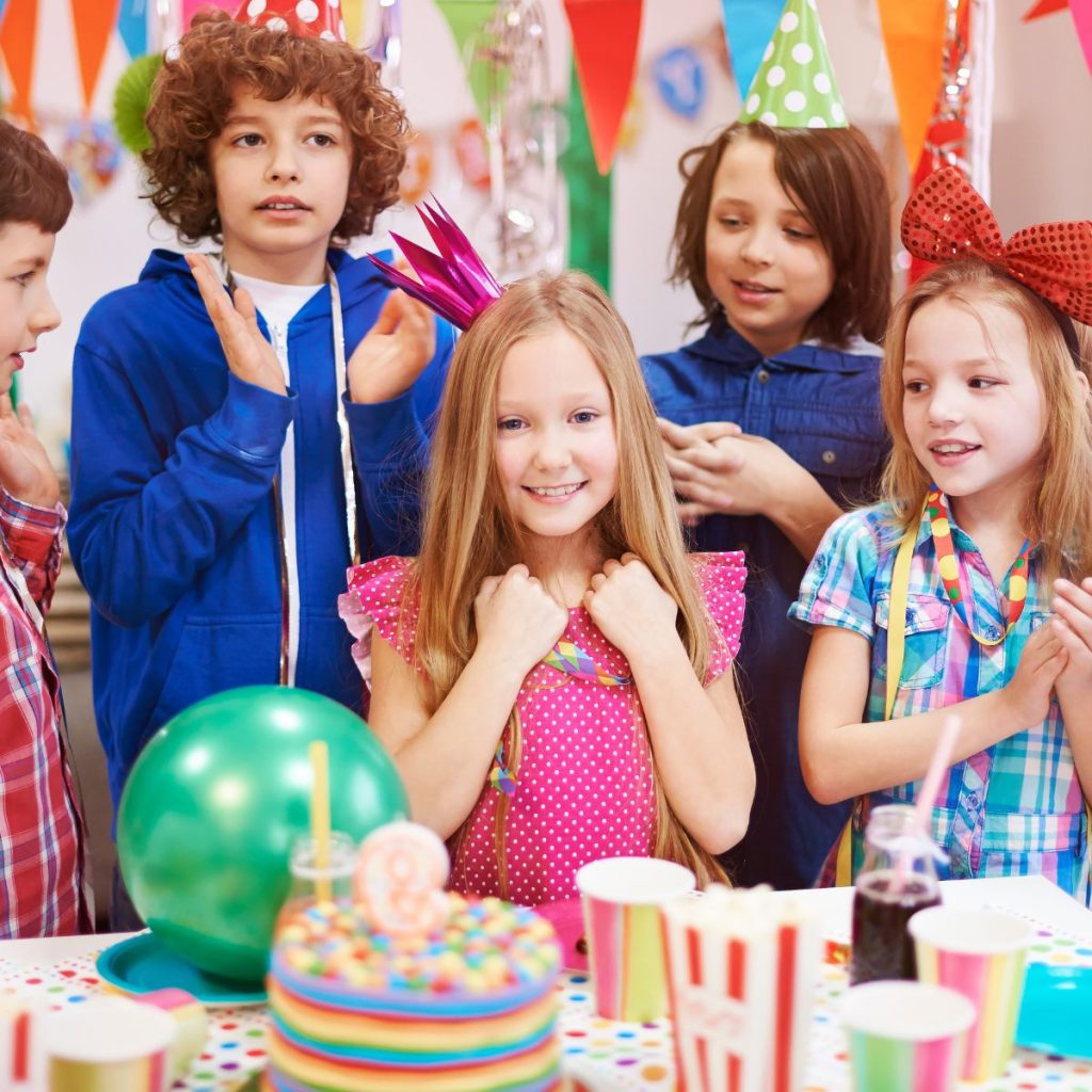 Kids celebrating a birthday at a party.