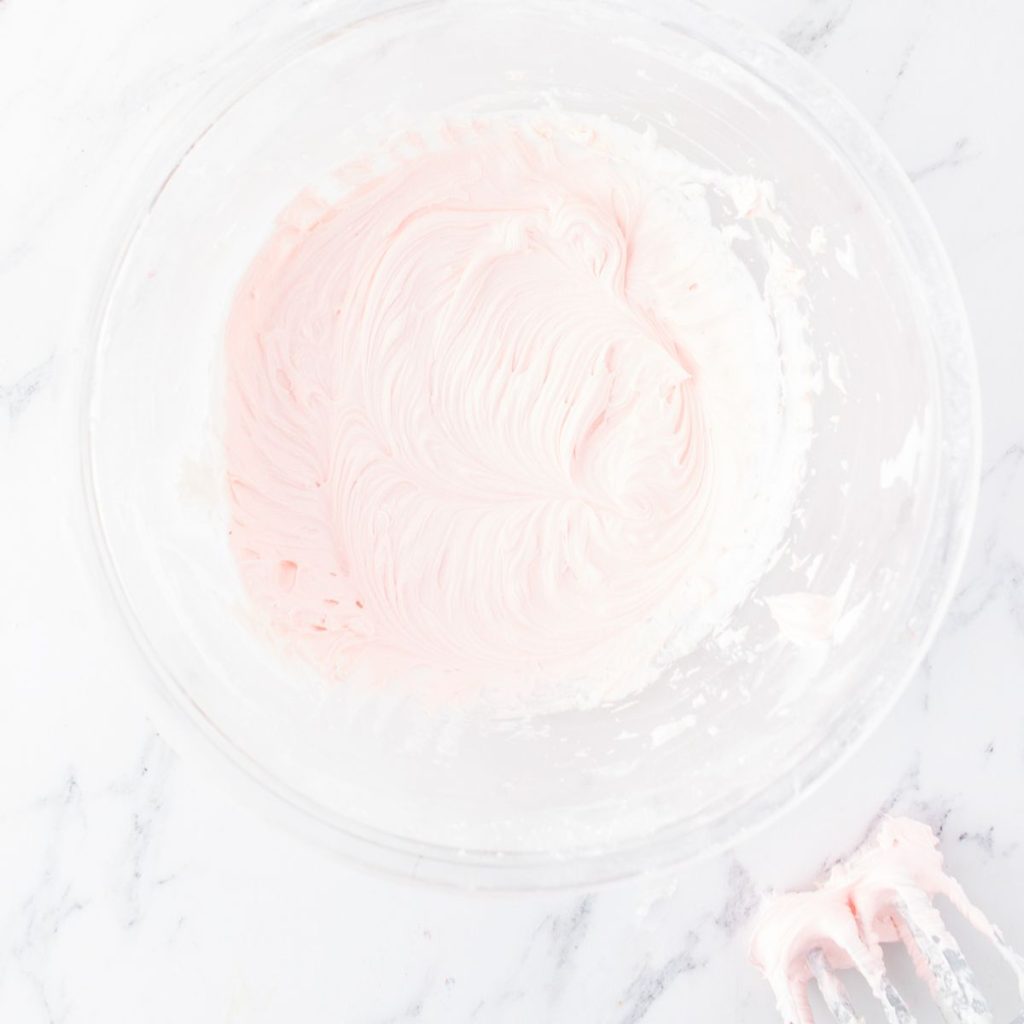 Bowl of pink frosting. 