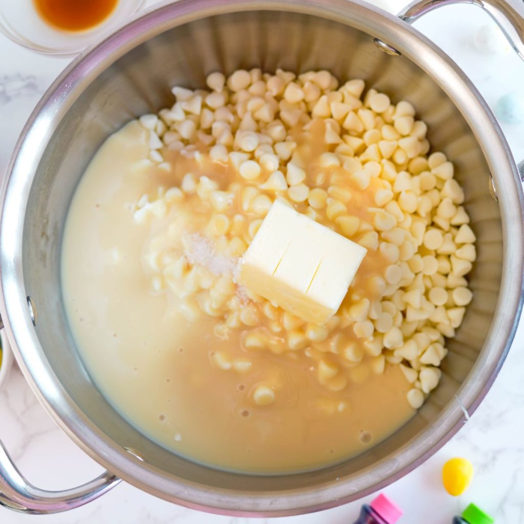 Double boiler with white chocolate chips, sweetened condensed milk and butter. 