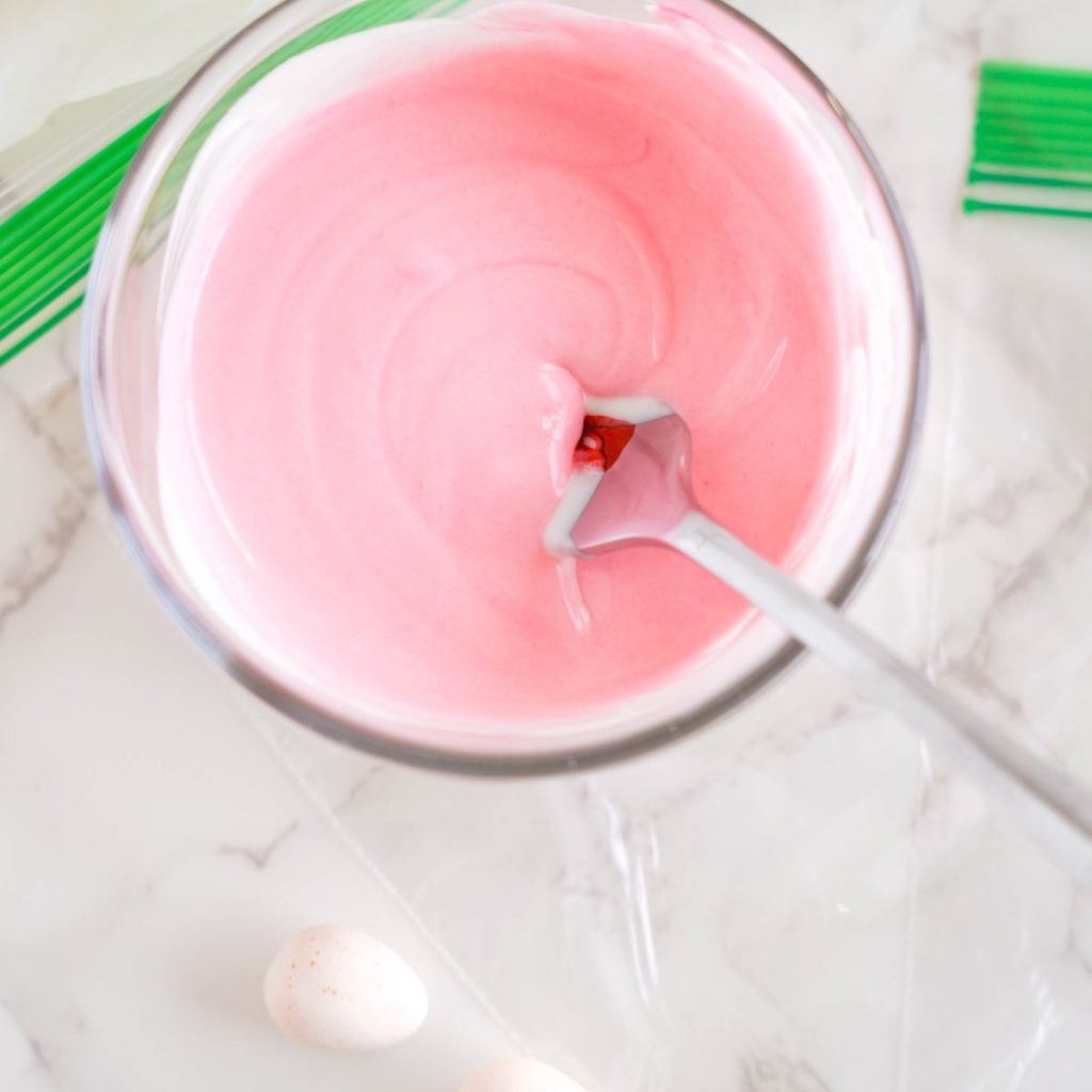 Bowl of white chocolate with pink food coloring. 