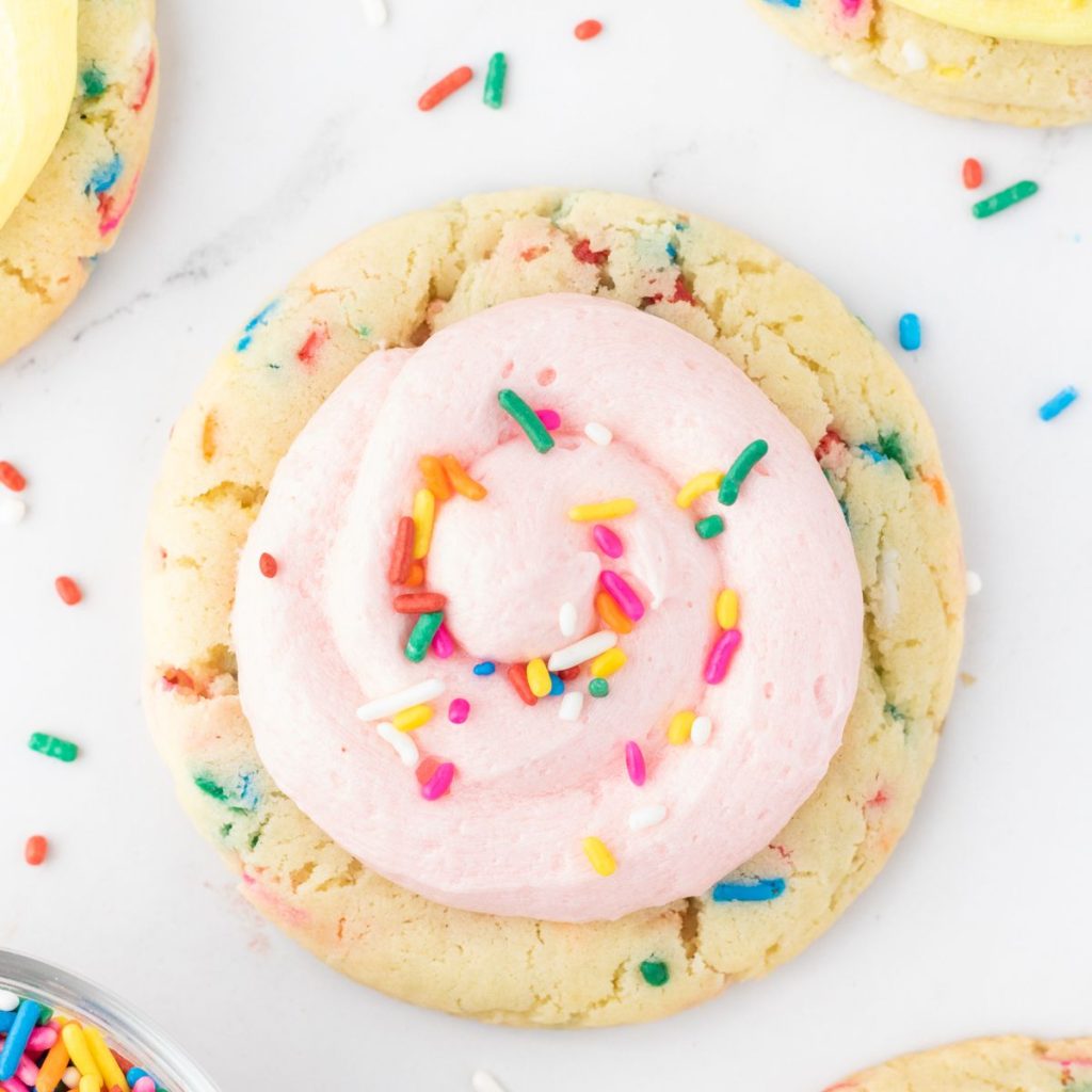 Sprinkle cookie with pink frosting. 