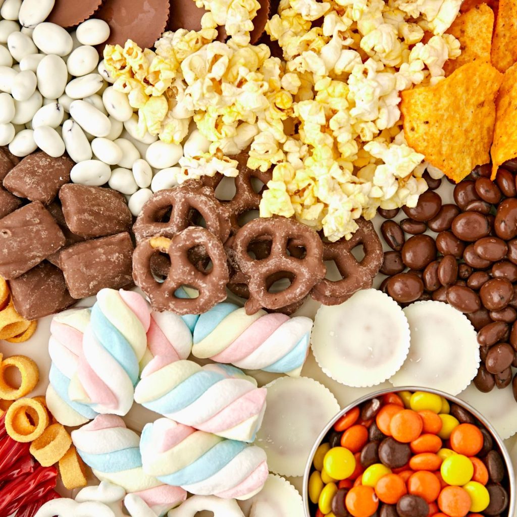 Tray with popcorn, chips, and candy. 