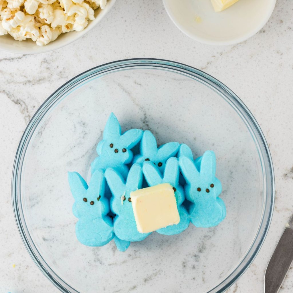 Bowl of blue Peeps marshmallows and butter.