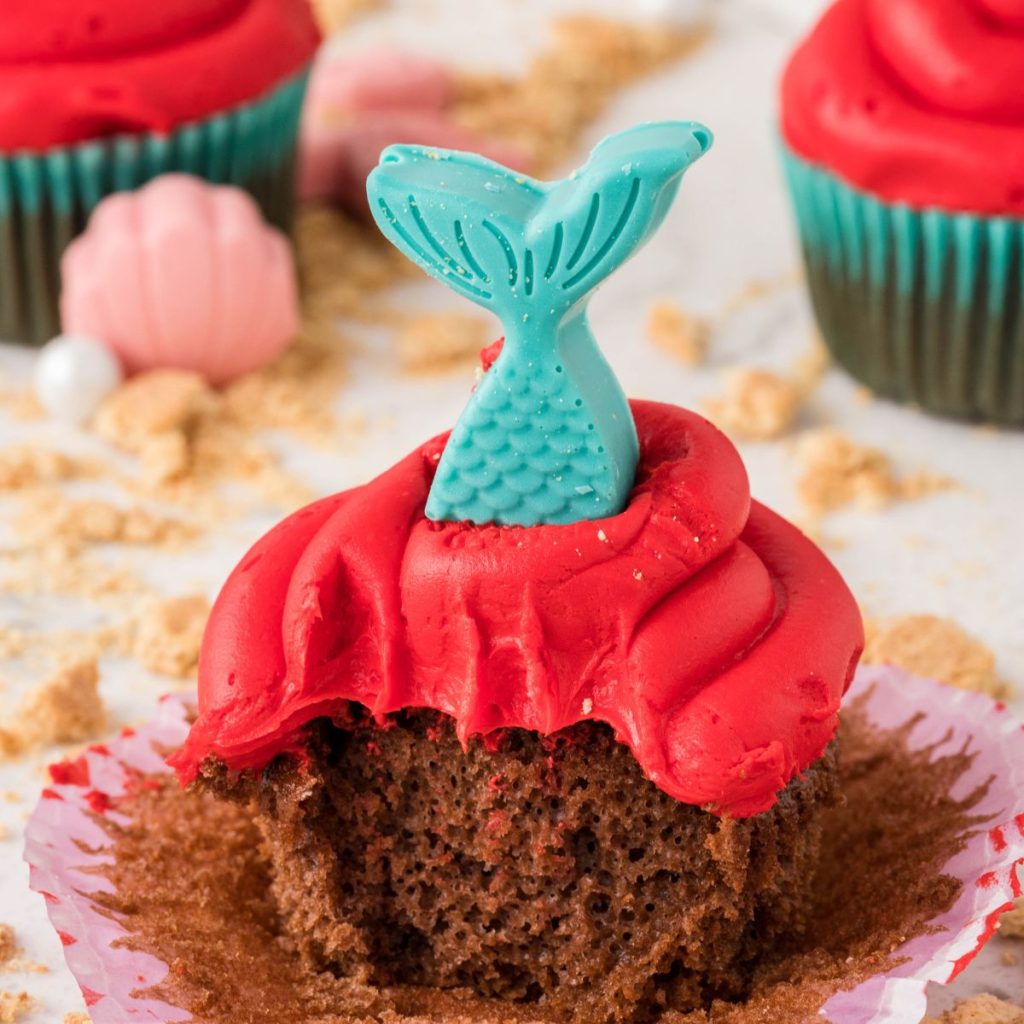 Chocolate cupcake with red frosting a blue tail. 