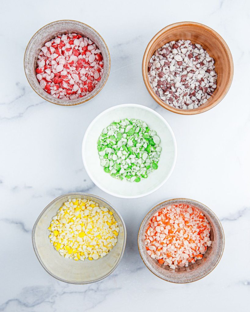 Bowls with crushed Skittles candy. 