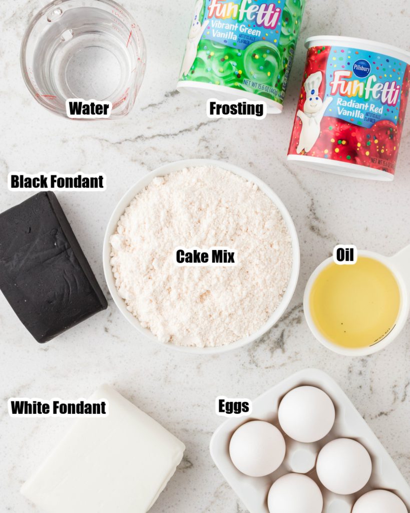 Bowl of cake mix, fondant, tubs of frosting, eggs, and oil. 