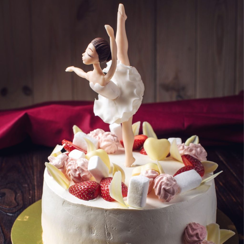 Cake with a ballerina topper. 