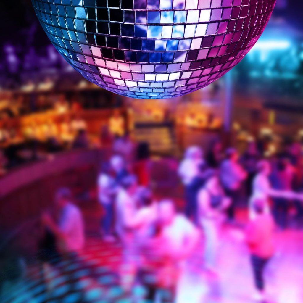 Disco ball with a party in background. 