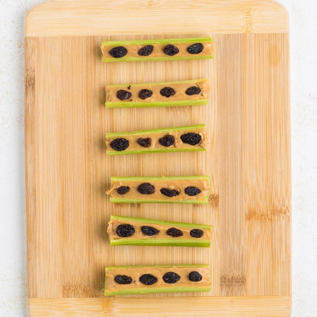 Celery stalks with peanut butter and raisins.