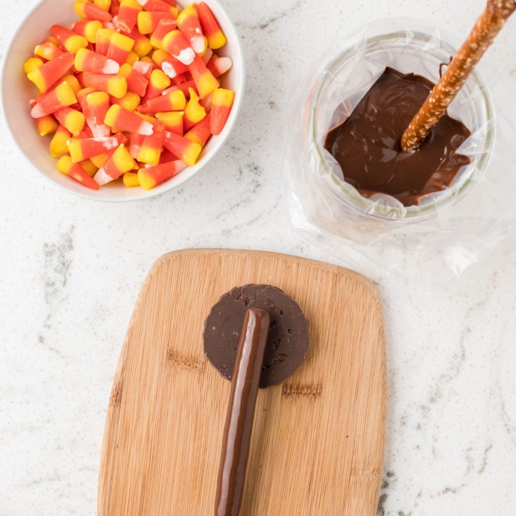 Pretzel rod covered in chocolate on a cookie.