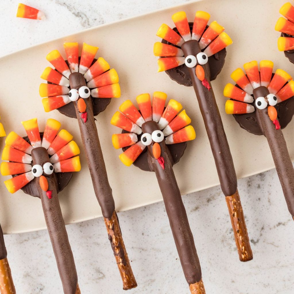 Pretzel rods decorated like turkeys with candy corn. 