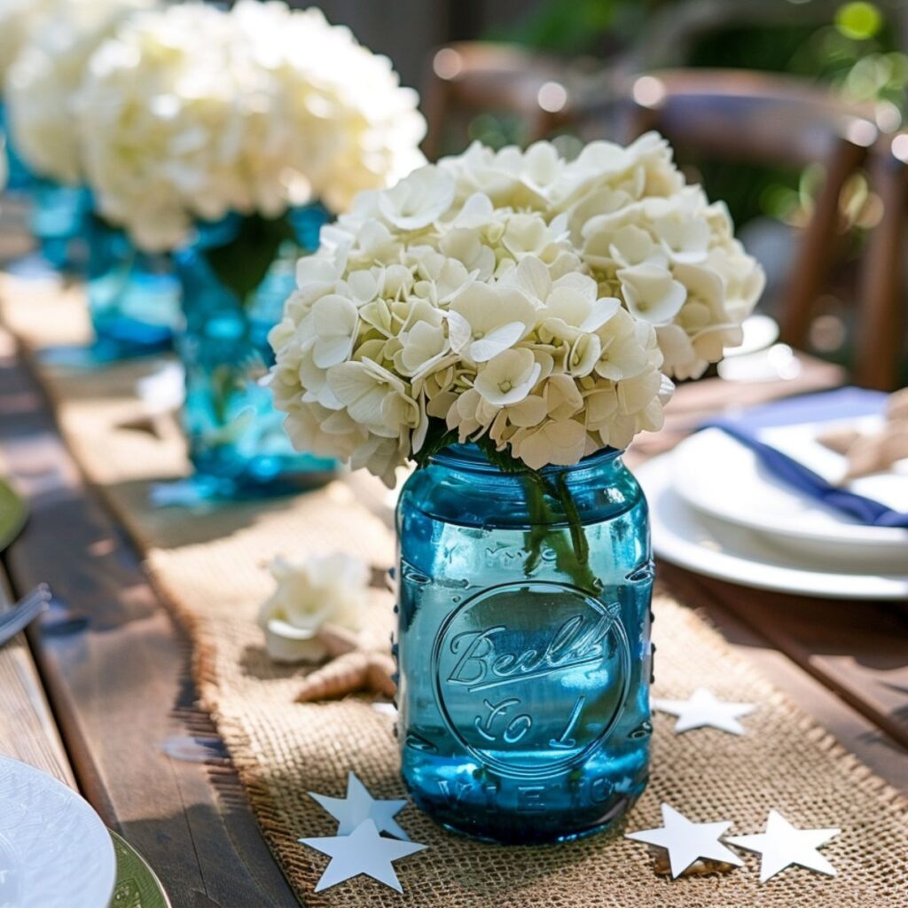 Blue jars filled with white flowers on a table. 