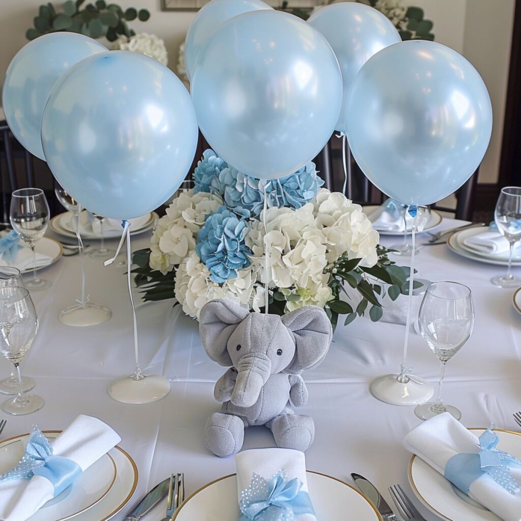 Table set for a party with a plush elephant and blue balloons.