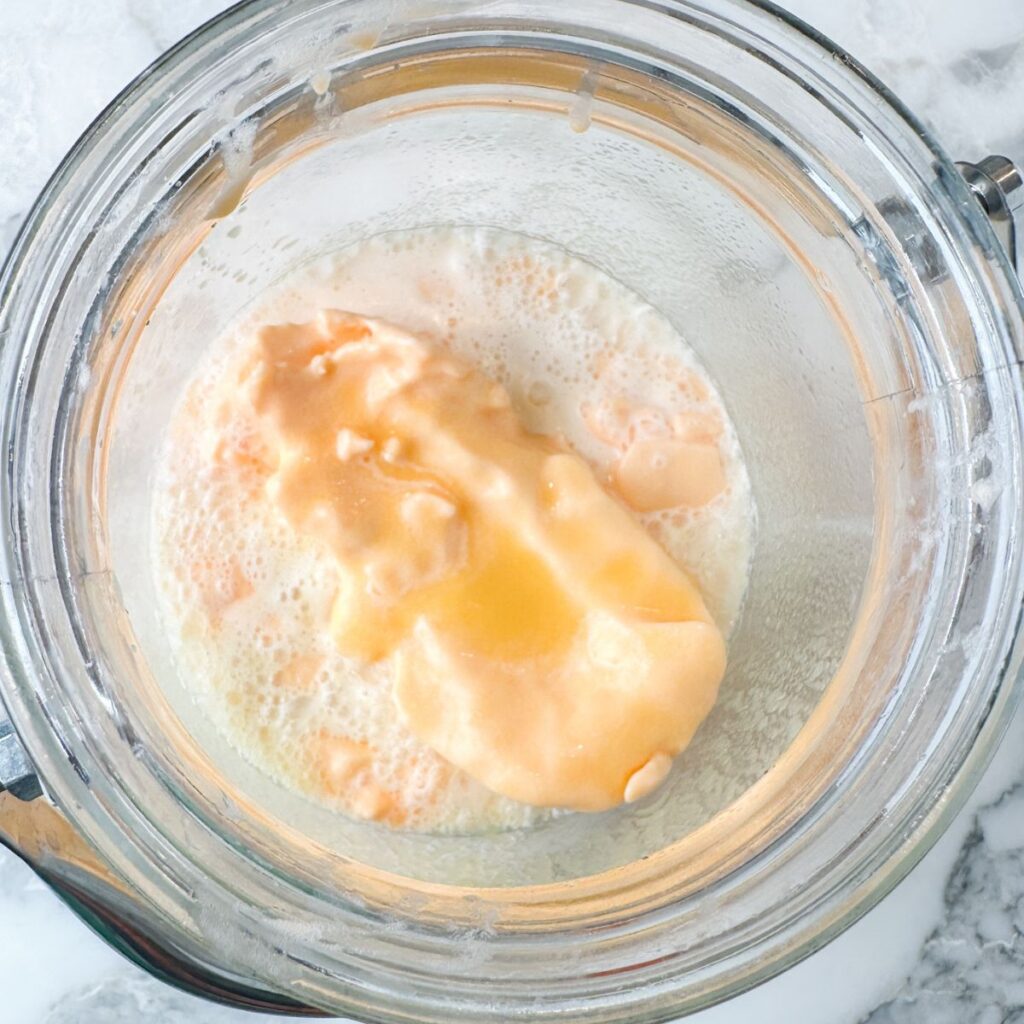 Drink container with orange sherbet.