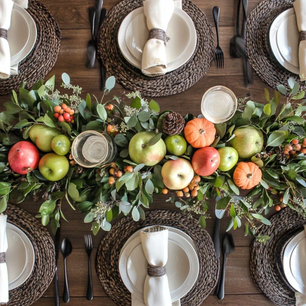 Table set with greenery and fruit.