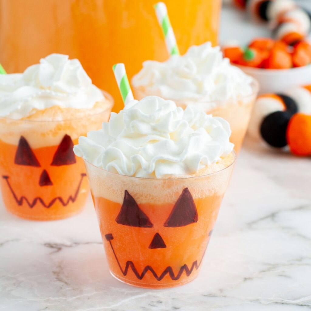 Cup with orange halloween punch.