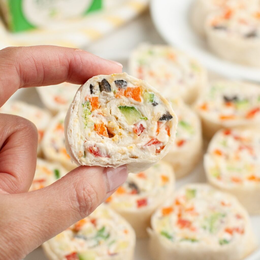 Hand holding a vegetable pinwheel.