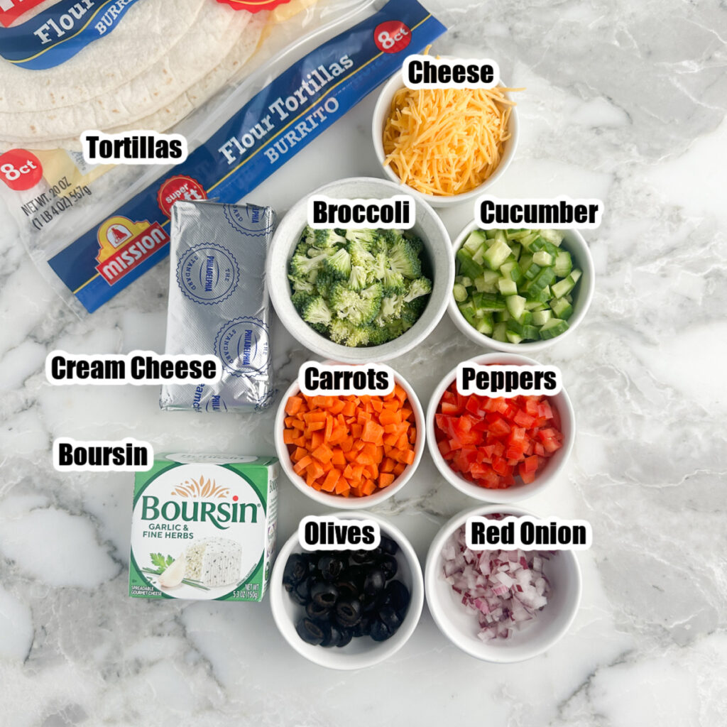 Cream cheese, Boursin cheese, bowls of shredded cheese, diced veggies, and tortillas.
