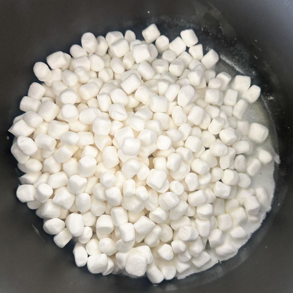 Pot with melted butter and mini marshmallows. 