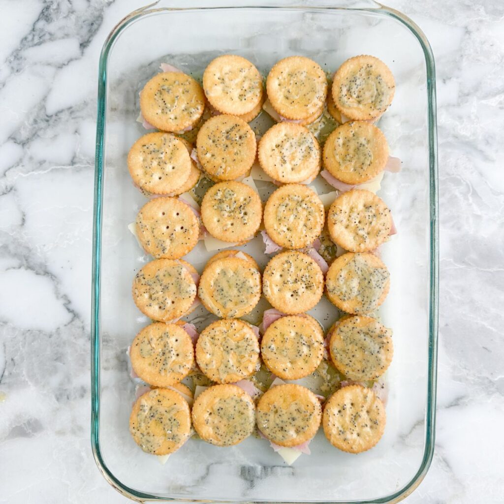 Baking dish with ham and cheese crackers. 