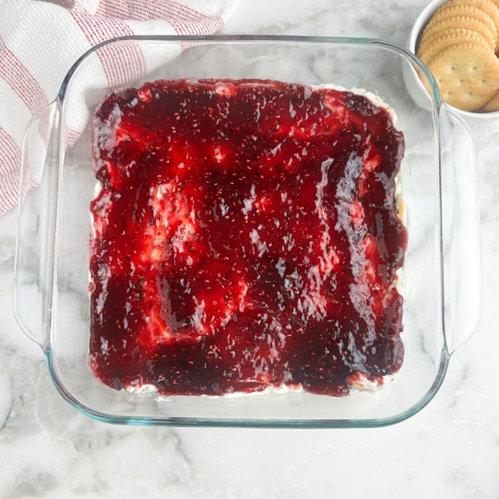 Cream cheese raspberry dip in a baking dish. 