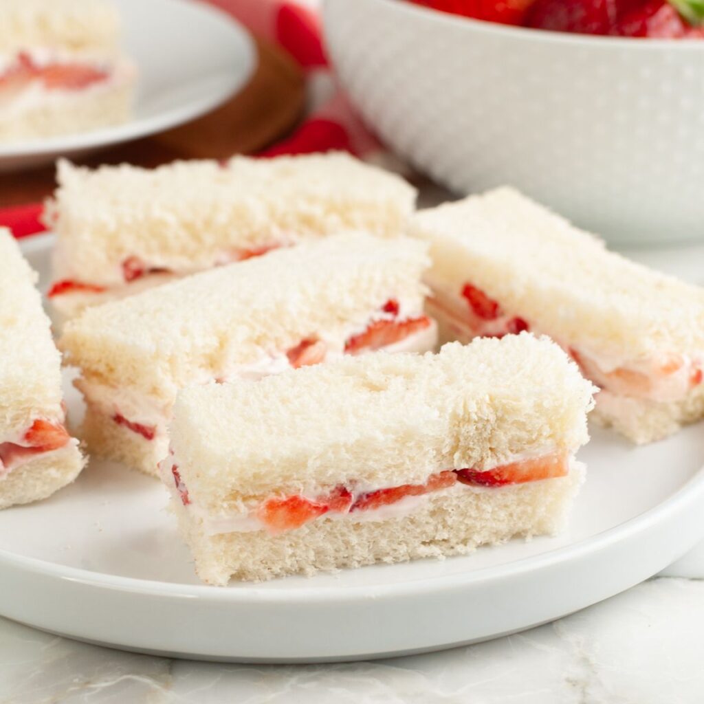 Strawberry tea sandwiches on a plate. 