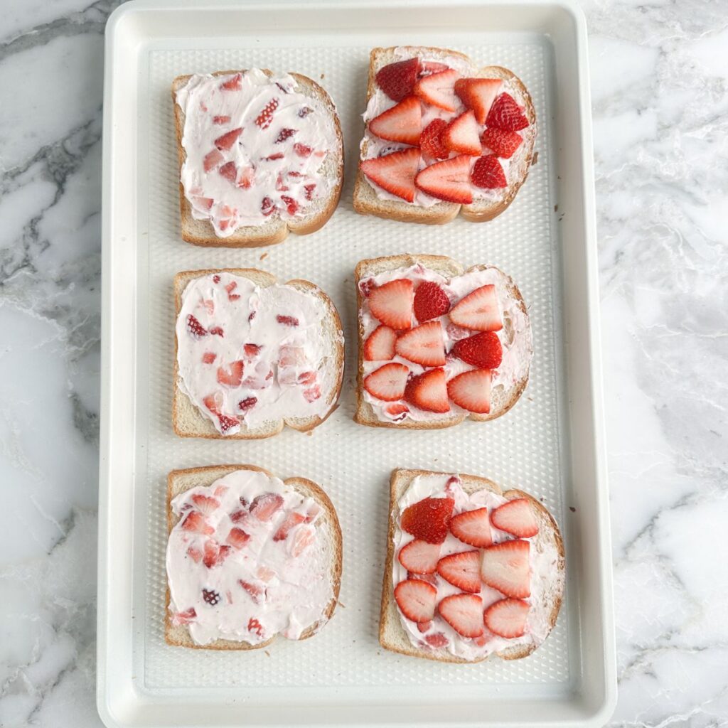 Pieces of bread with strawberry cream cheese. 